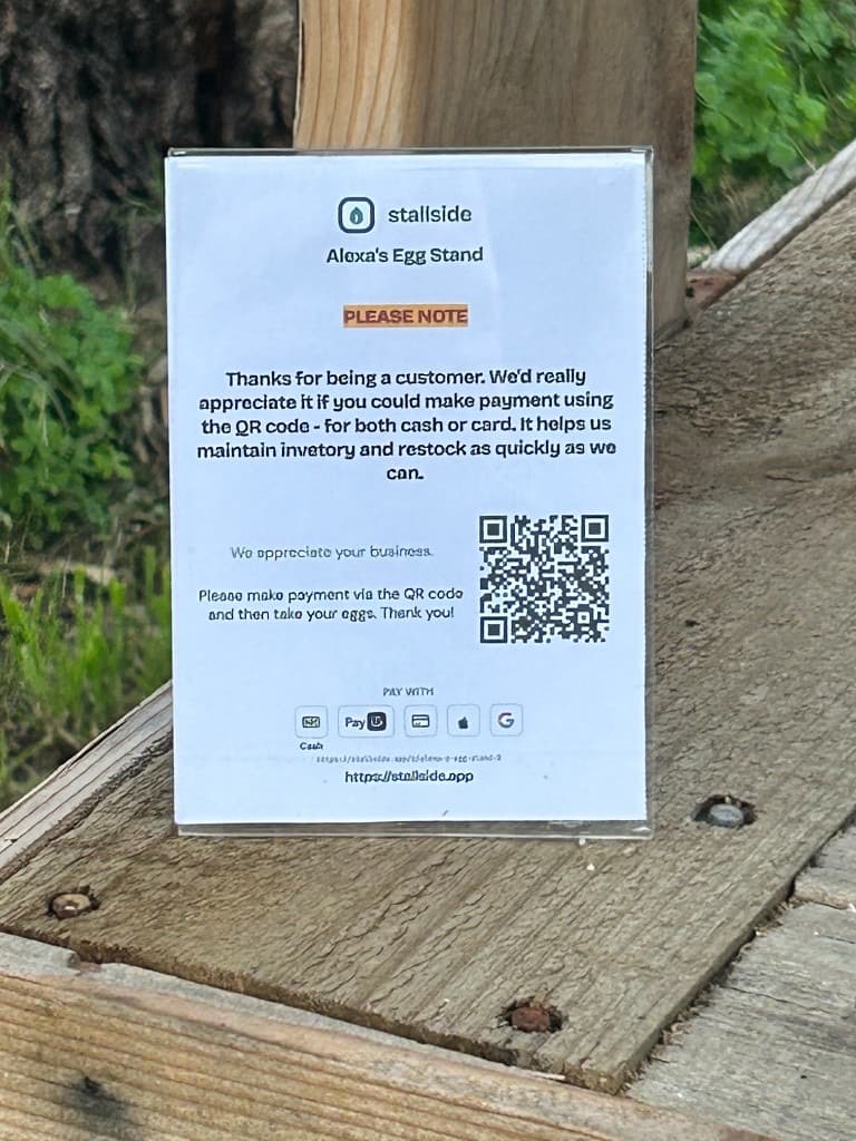 Printed Vendl QR sign for Alexa's Egg Stand in a clear stand, showing cash, PayID, and Tap & Go payment icons